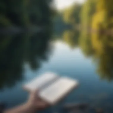 A person reflecting by a calm lake with a book in hand