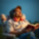 An individual relaxing with headphones and a book by their side